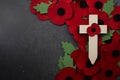 Remembrance Day poppy symbol on wooden cross. 11th November is a memorial day of the First World War. Royalty Free Stock Photo