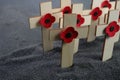 Remembrance Day poppy symbol on wooden cross. 11th November is a memorial day of the First World War. Royalty Free Stock Photo