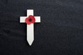 Remembrance Day poppy symbol on wooden cross. 11th November is a memorial day of the First World War. Royalty Free Stock Photo