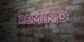 REMIND - Glowing Neon Sign on stonework wall - 3D rendered royalty free stock illustration