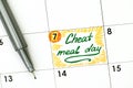 Reminder Cheat Meal Day in calendar with green pen. Royalty Free Stock Photo