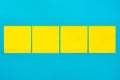 Reminder and combination concept- Close up four yellow empty square stickers on blue background with copy spase, mock up Royalty Free Stock Photo