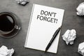 Reminder DON`T FORGET written in notebook on grey table, flat lay