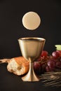 First communion reminder with cup and bread on black Royalty Free Stock Photo