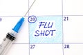 Reminder Flu Shot in calendar with syringe