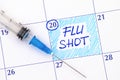 Reminder Flu Shot in calendar with syringe