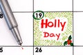 Reminder Holly Day in calendar with pen Royalty Free Stock Photo