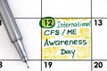 Reminder International CFS/ ME Awareness Day in calendar with pen Royalty Free Stock Photo