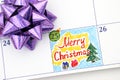 Reminder Merry Christmas in calendar with bow Royalty Free Stock Photo