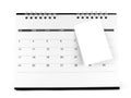 Blank paper sticky note attaching on desk calendar page with days and date isolated on white background Royalty Free Stock Photo