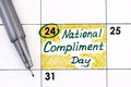 Reminder National Compliment Day in calendar with pen