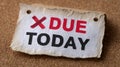 Reminder note with 'Due Today' text on corkboard background. Royalty Free Stock Photo