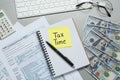 Reminder note with words Tax Time, documents, money and computer keyboard on grey table, flat lay Royalty Free Stock Photo