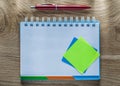 Reminder notes spiral notebook pen on wooden board Royalty Free Stock Photo