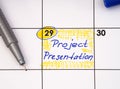 Reminder Project Presentation in calendar with a blue pen