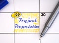 Reminder Project Presentation in the calendar with a blue pen