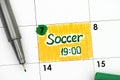 Reminder Soccer 19-00 in calendar with green pen.