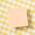 Reminder sticky note on yellow check pattern fabric background