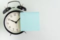 Reminder, time, deadline, stop procrastination or meeting schedule concept, alarm clock with blank sticky note on top for text and Royalty Free Stock Photo
