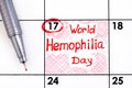 Reminder World Hemophilia Day in calendar with pen