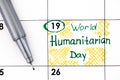 Reminder World Humanitarian Day in calendar with pen