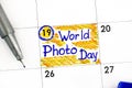 Reminder World Photo Day in calendar with pen