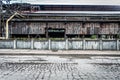 Remnants of an abandoned industrial factory with cracked pavement