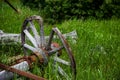 Broken-Down Wooden Wagon Wheel in the Grass Royalty Free Stock Photo