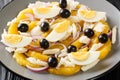 Remojon salad of oranges, boiled salted fish, eggs and red onions close-up in a plate. Horizontal