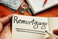 Remortgage handwritten word by man Royalty Free Stock Photo