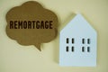 Remortgage Home Renovation text message on speech bubble with house model on yellow background Royalty Free Stock Photo