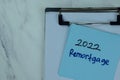 2022 Remortgage write on sticky notes isolated on Wooden Table Royalty Free Stock Photo