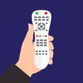 TV remote control device isolated in hand on blue background. Royalty Free Stock Photo