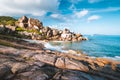 Remote beach Grand L Anse, La Digue, Seychelles. Tropical ocean coast, unique granite rocks and lonely sail boat in sea Royalty Free Stock Photo