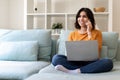 Remote Business. Arab Woman Talking On Phone And Using Laptop At Home Royalty Free Stock Photo