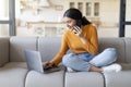 Remote Business. Indian Woman Talking On Phone And Using Laptop At Home Royalty Free Stock Photo