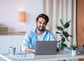 Remote Career. Happy Arab Male Entrepreneur Sitting At Desk With Laptop Royalty Free Stock Photo