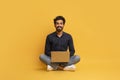 Remote Career. Happy Indian Man With Laptop Computer Sitting On Floor