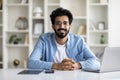 Remote Career. Smiling Indian Male Freelancer Posing At Desk In Home Office