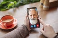 Woman making video call with old man using smartphone Royalty Free Stock Photo