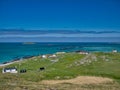 A remote community on the coast of the island of Eriskay.Taken on a calm day in summer with blue skies and turquoise water