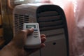 Remote control and air conditioner in a dark room Royalty Free Stock Photo