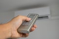 Remote control of air conditioner in hand Royalty Free Stock Photo