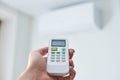 Remote control for air conditioner in hand Royalty Free Stock Photo