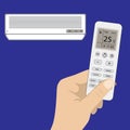 Remote control of air conditioner in hand and white air conditio Royalty Free Stock Photo