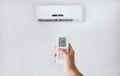 Remote control for air conditioner on a white wall. Royalty Free Stock Photo