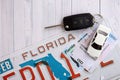 Remote control car keys on Florida license plate with driver license. Car driving in Florida Royalty Free Stock Photo