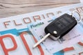 Remote control car keys on Florida license plate with driver license. Car driving in Florida Royalty Free Stock Photo