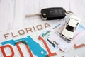 Remote control car keys on Florida license plate with driver license. Car driving in Florida Royalty Free Stock Photo
