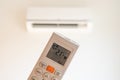 remote control command for air conditioning to be handled point to the device with the order to 21Â°C Royalty Free Stock Photo